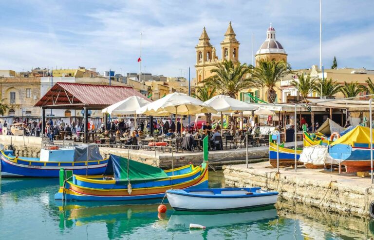 Colourful luzzu fishing boats in Valletta Grand Harbour — best place to stay in Malta for couples
