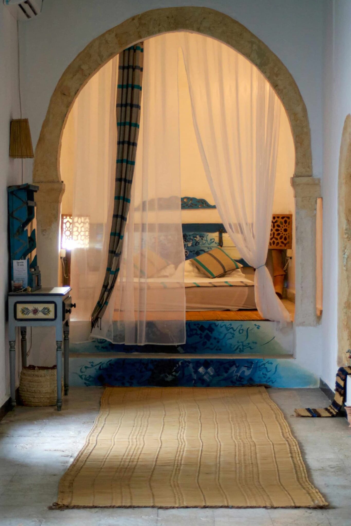 Romantic stone arch bedroom with canopy bed and soft lighting — the kind of boutique room that makes a couple's trip to Malta memorable