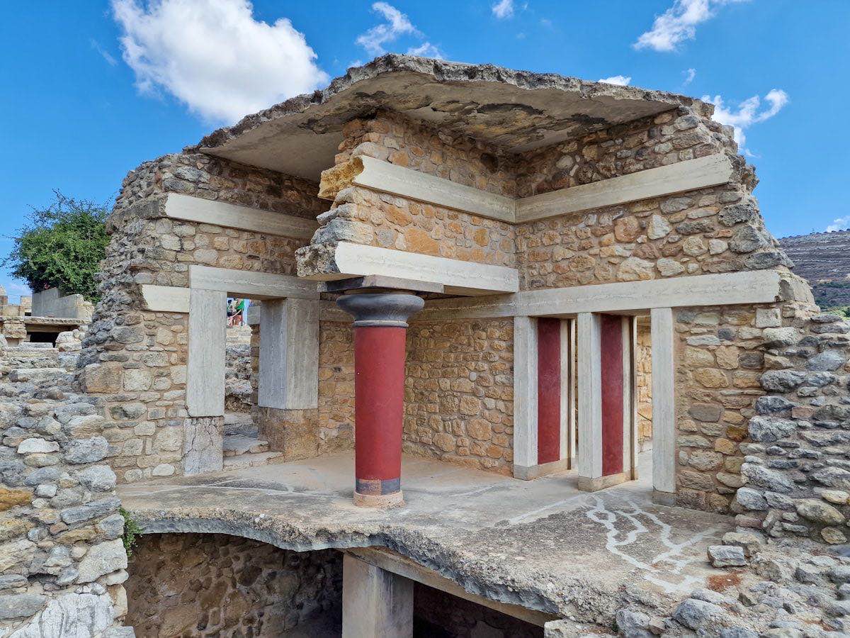 Reconstructed columns and frescoed walls of the Palace of Knossos on Crete in morning light