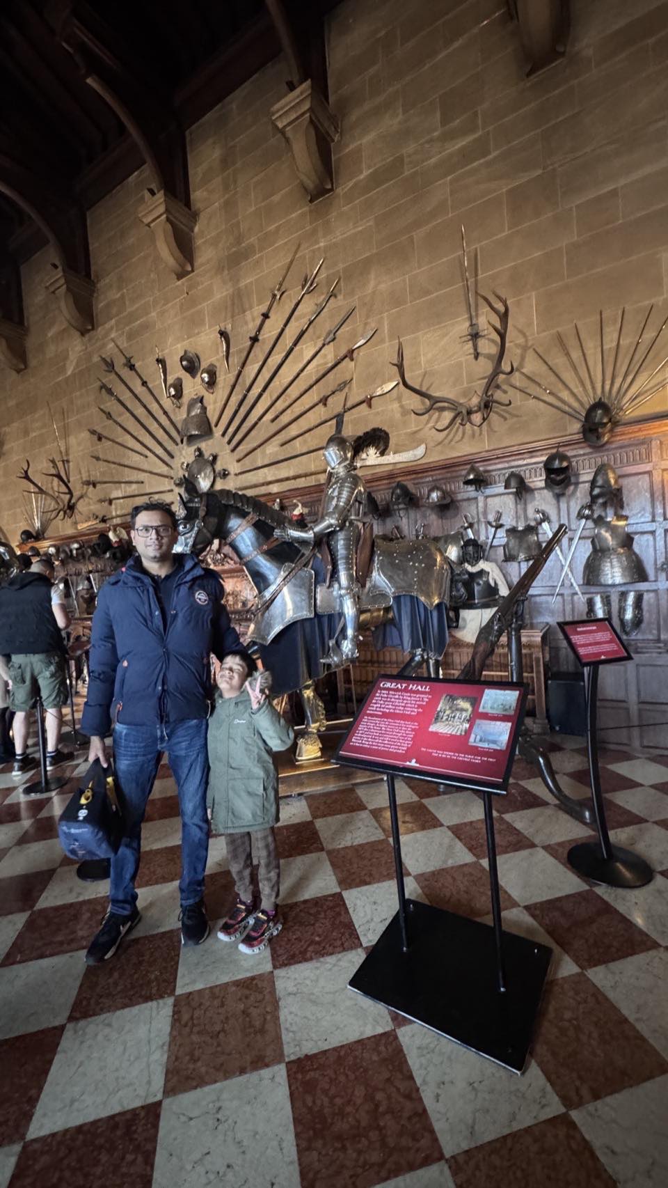 The Great Hall at Warwick Castle filled with historic armour, weapons and shields on display