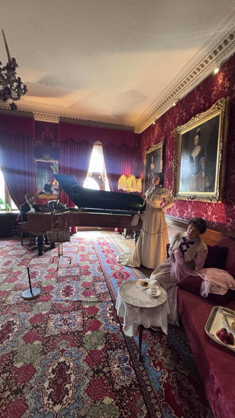 The ornate Victorian state rooms at Warwick Castle, with wax figures and red velvet furnishings